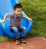 Boy smiling on slide